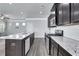 Modern kitchen with dark cabinetry, granite countertops, and stainless steel appliances at 204 Hickory Commons Way, Canton, GA 30115