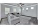 Spacious living room with gray walls, wood-look flooring, and neutral-toned furniture at 204 Hickory Commons Way, Canton, GA 30115