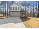 Two-story house with stone accents and a two-car garage, nestled among tall trees at 3170 Old Hwy 92 Dr, Acworth, GA 30102