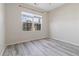 Bright bedroom with neutral walls and wood-look flooring at 6397 Barker Station Walk, Sugar Hill, GA 30518