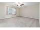 Spacious bedroom with window and ceiling fan at 6397 Barker Station Walk, Sugar Hill, GA 30518