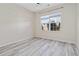 Bright bedroom with neutral walls and wood-look flooring at 6397 Barker Station Walk, Sugar Hill, GA 30518