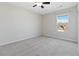 Neutral-toned bedroom with ceiling fan and window at 6397 Barker Station Walk, Sugar Hill, GA 30518