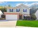 Two-story house with brick and siding, a large yard, and a two-car garage at 6397 Barker Station Walk, Sugar Hill, GA 30518