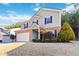 Two-story house with brick and siding, a large yard, and a two-car garage at 6397 Barker Station Walk, Sugar Hill, GA 30518