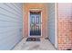 Dark-colored front door with brick and siding accents at 6397 Barker Station Walk, Sugar Hill, GA 30518