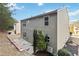 Gray house exterior with windows and a small patio area at 6397 Barker Station Walk, Sugar Hill, GA 30518