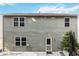 Gray house exterior with multiple windows and a back patio at 6397 Barker Station Walk, Sugar Hill, GA 30518