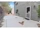 Back exterior of a gray house with a patio and door at 6397 Barker Station Walk, Sugar Hill, GA 30518