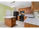 Modern kitchen with island, stainless steel appliances, and light wood cabinets at 6397 Barker Station Walk, Sugar Hill, GA 30518