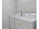 Laundry room with washer, dryer, and overhead shelving at 6397 Barker Station Walk, Sugar Hill, GA 30518