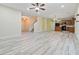 Open living room and kitchen with light wood-look flooring at 6397 Barker Station Walk, Sugar Hill, GA 30518