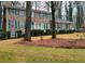 Two-story brick home with green shutters, landscaping, and a driveway at 714 Weatherborn Pl, Stone Mountain, GA 30083