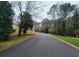 Residential street lined with lush trees and homes at 714 Weatherborn Pl, Stone Mountain, GA 30083