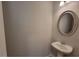 Small powder room with pedestal sink and oval mirror at 80 Heyman Dr, Covington, GA 30016