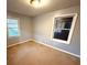 Simple bedroom with two windows and tan carpet at 891 Daniell Se Dr, Smyrna, GA 30080