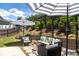 Relaxing backyard patio with pergola, comfortable seating, and outdoor umbrellas at 121 Treeline Trl, Canton, GA 30115