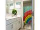 Bright bathroom with double vanity and rainbow shower curtain at 121 Treeline Trl, Canton, GA 30115