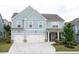 Two story house with light blue siding, three car garage, and landscaped yard at 121 Treeline Trl, Canton, GA 30115