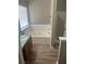 Bathroom with bathtub, shower, and wood-look flooring at 3575 Oakvale Falls Ct, Decatur, GA 30034