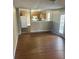 Open dining area with kitchen view and laminate flooring at 3575 Oakvale Falls Ct, Decatur, GA 30034