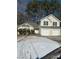 Two-story house with a two-car garage and snow-covered yard at 3575 Oakvale Falls Ct, Decatur, GA 30034