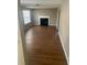 Living room with fireplace and wood-look laminate flooring at 3575 Oakvale Falls Ct, Decatur, GA 30034