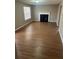 Living room with fireplace and wood-look laminate flooring at 3575 Oakvale Falls Ct, Decatur, GA 30034