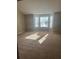 Bright living room featuring a bay window and carpeted floors at 3575 Oakvale Falls Ct, Decatur, GA 30034