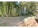 Wooded backyard with spacious lawn area at 4045 White Oak Sw Ln, Lilburn, GA 30047