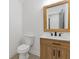 Modern bathroom with a wood vanity and a large mirror at 4045 White Oak Sw Ln, Lilburn, GA 30047