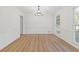 Bright dining room with hardwood floors and chandelier at 4045 White Oak Sw Ln, Lilburn, GA 30047