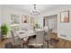 Virtually staged dining room features a marble table and chandelier at 4045 White Oak Sw Ln, Lilburn, GA 30047