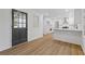 Light and airy entryway with dark gray door leading to the kitchen at 4045 White Oak Sw Ln, Lilburn, GA 30047