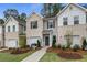 Brick townhome with attached garage, landscaping, and welcoming front porch at 451 Payne Dr, Mcdonough, GA 30253