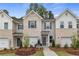 Curb appeal abounds in this townhome community featuring attached garages and landscaping at 451 Payne Dr, Mcdonough, GA 30253