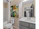 Bright bathroom showcasing a vanity with sink, toilet, bathtub, and framed abstract art at 455 Payne Dr, Mcdonough, GA 30253