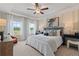 Relaxing bedroom with neutral color scheme, tray ceiling, and large windows with outside view at 455 Payne Dr, Mcdonough, GA 30253