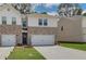 Two-story townhome with brick and white exterior, two-car garage at 455 Payne Dr, Mcdonough, GA 30253