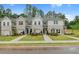 New townhomes featuring light brick, siding, and well-manicured lawns create a welcoming curb appeal at 455 Payne Dr, Mcdonough, GA 30253