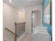 Upstairs hallway with carpet flooring, wooden banister, and a view into a bedroom at 455 Payne Dr, Mcdonough, GA 30253