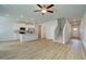 Open living room and kitchen with LVP flooring and ceiling fan at 455 Payne Dr, Mcdonough, GA 30253