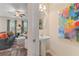 Stylish powder room adjacent to a cozy living area, featuring a pedestal sink and colorful artwork at 455 Payne Dr, Mcdonough, GA 30253