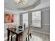 Dining room with gray walls, wood-look floors, and a wood dining table at 5102 Anclote Dr, Alpharetta, GA 30022