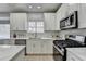 Modern kitchen with white cabinets and stainless steel appliances at 5102 Anclote Dr, Alpharetta, GA 30022