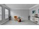 Living room with gray walls, wood-look floors, and a mustard-colored armchair at 5102 Anclote Dr, Alpharetta, GA 30022