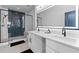 Modern bathroom featuring a stylish vanity with double sinks, an illuminated mirror, and a glass enclosed shower at 160 Vanira Se Ave # A, Atlanta, GA 30315