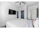 This bedroom features a ceiling fan, tv, and a full length mirror with a white door at 160 Vanira Se Ave # A, Atlanta, GA 30315