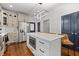 Bright kitchen features stainless appliances, white backsplash and countertops and island with seating at 160 Vanira Se Ave # A, Atlanta, GA 30315