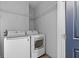 Laundry room featuring white washer and dryer units, complemented by practical shelving at 160 Vanira Se Ave # A, Atlanta, GA 30315